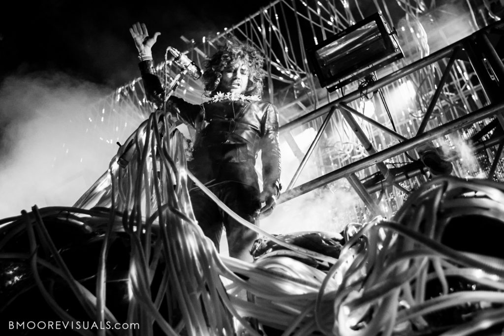 Black and white photo of Wayne Coyne of The Flaming Lips performing during Gasparilla Music Festival in Tampa, Florida