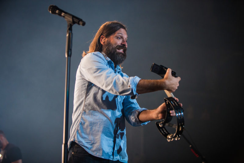 Mac Powell of Third Day grabs a fan's camera during the Third Day and Friends concert at Infinite Energy Center in Atlanta, Georgia