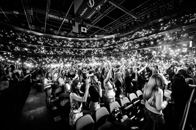 Fans light up the arena as Ed Sheeran performs during 93.3 FLZ's Jingle Ball in Tampa, Florida