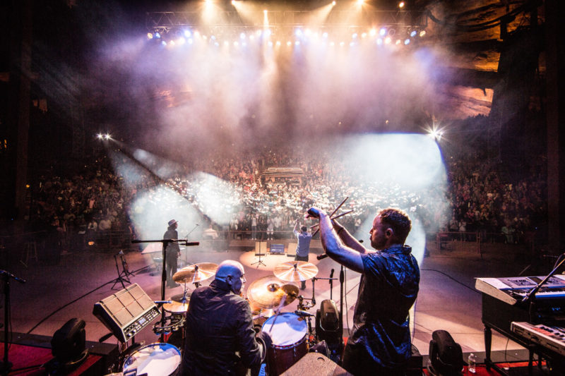 Peter Furler plays drums as David Carr of Third Day watches on June 14, 2015 at Red Rocks Amphitheater in Morrison, Colorado