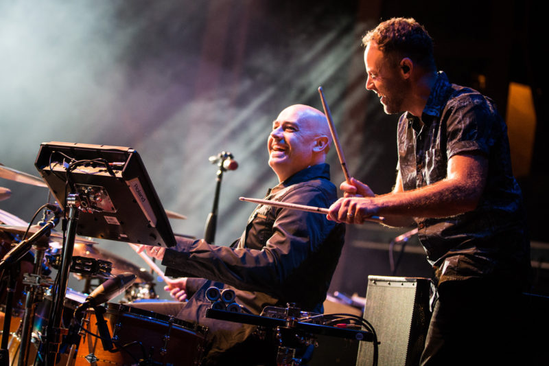 Peter Furler plays drums as David Carr of Third Day watches on June 14, 2015 at Red Rocks Amphitheater in Morrison, Colorado