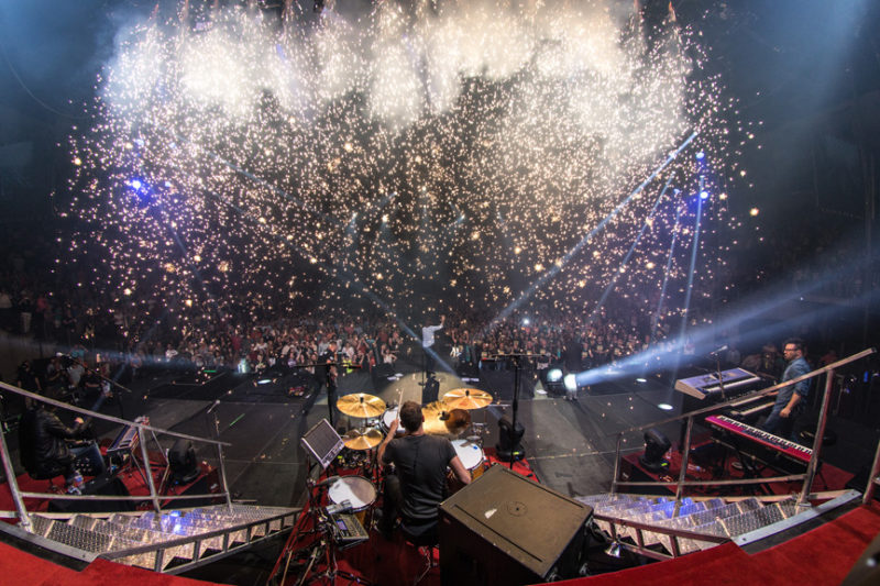 Sparks fly as Tai Anderson, David Carr, and Mac Powell of Third Day perform at Infinite Energy Center in Atlanta, Georgia