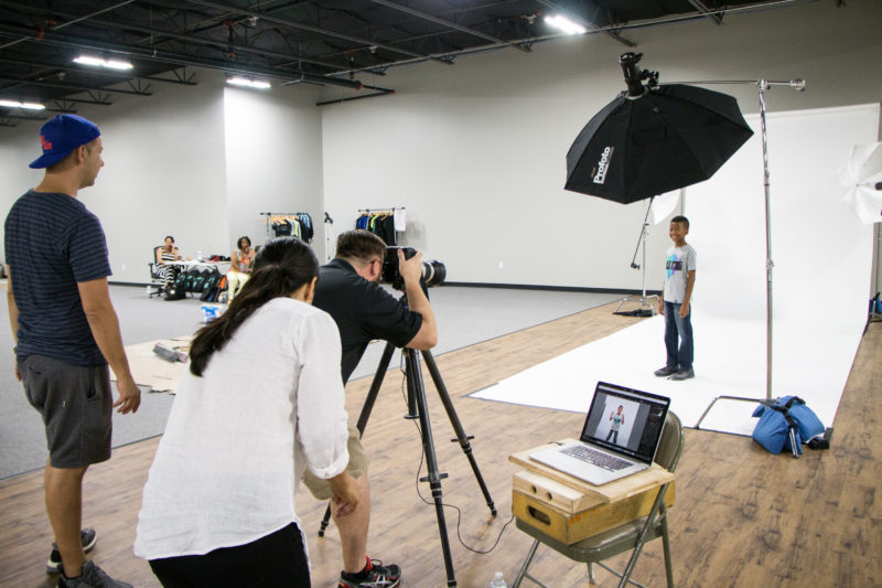 Photographing one of the youth models while Chief Creative Officer Joel Cook and Stylist Ana Patiño make sure everything is looking good. Photo by Ashley Allen