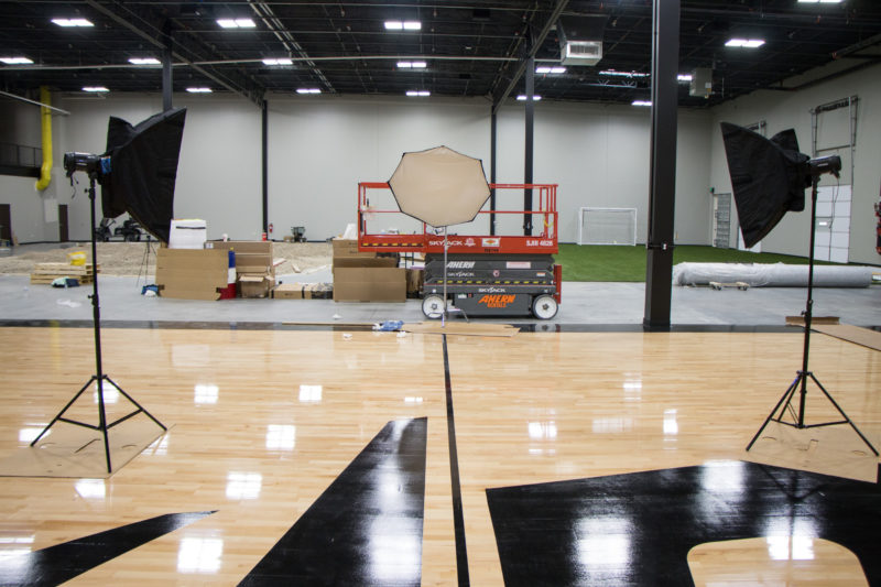 Studio lights set up on the Dude Perfect basketball court at their headquarters in Frisco, Texas